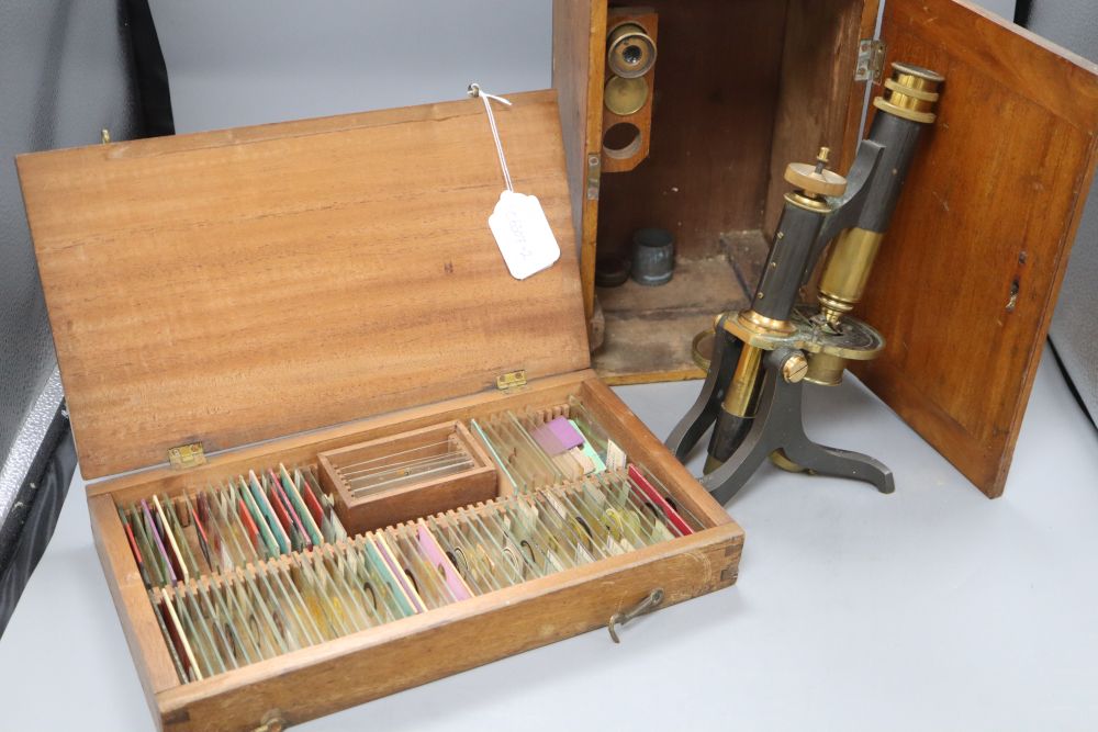 A Negretti and Zambra cased brass microscope and various specimen slides
